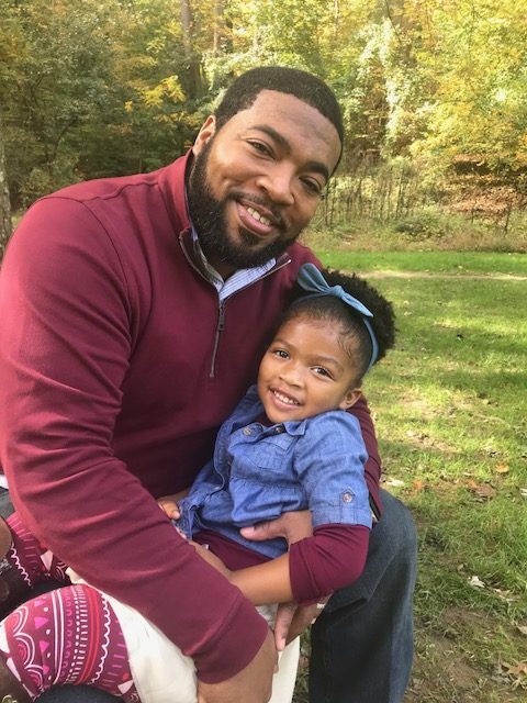 Writer Olu Burrell and his daughter.