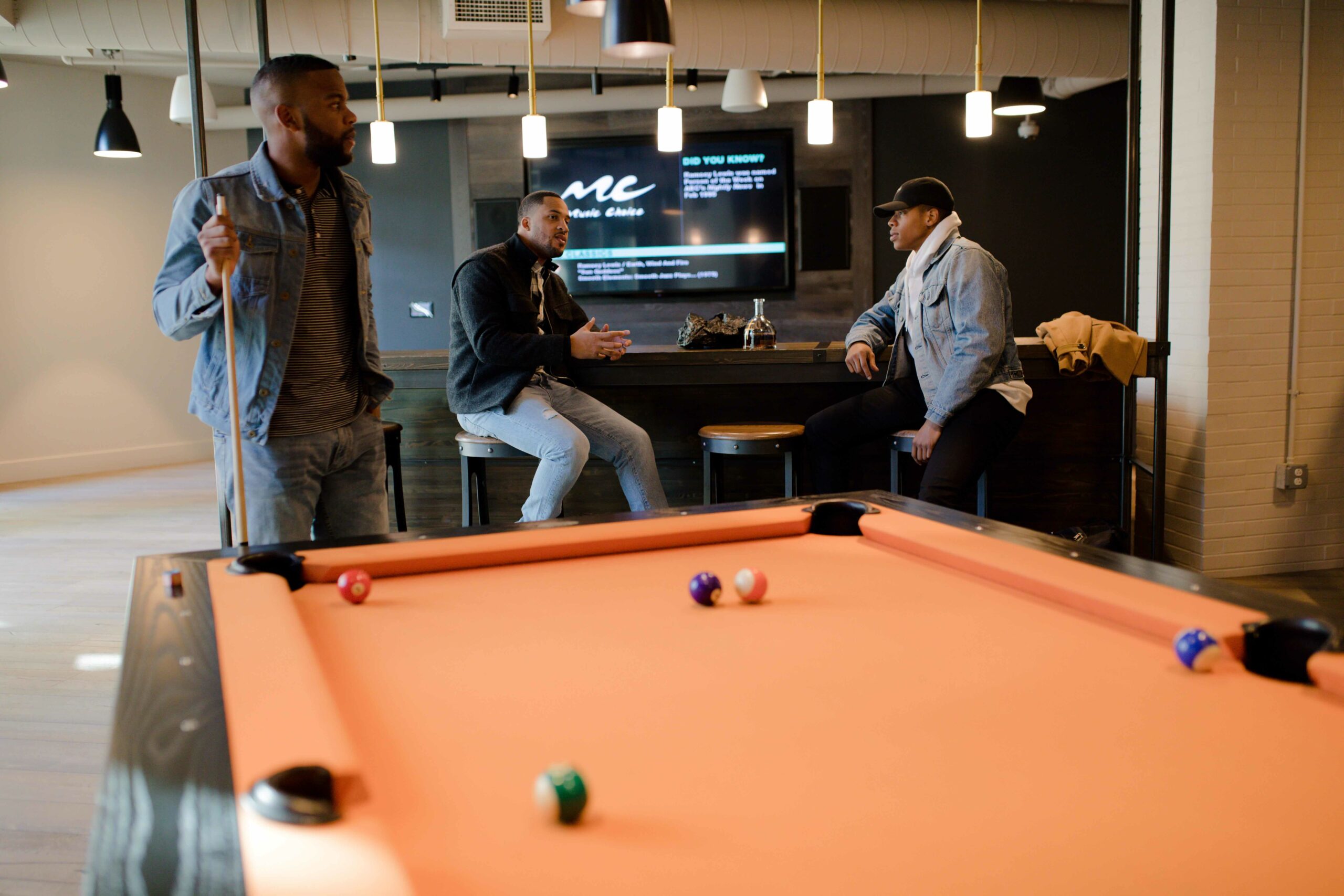 Men talking at a pool table