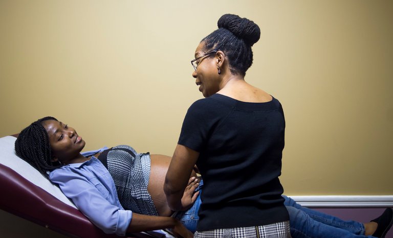 British-born midwife Jennie Joseph with a patient (Photo courtesy of jenniejoseph.com)