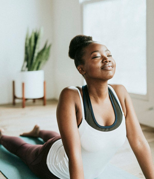 Woman stretching (Photo courtesy of Rawpixel.com)