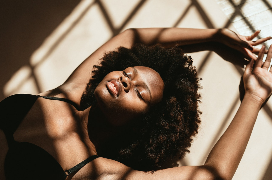 Woman laying on the floor (Photo courtesy of rawpixel.com)