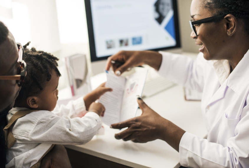 Black doctor with child (Courtesy of rawpixel.com)