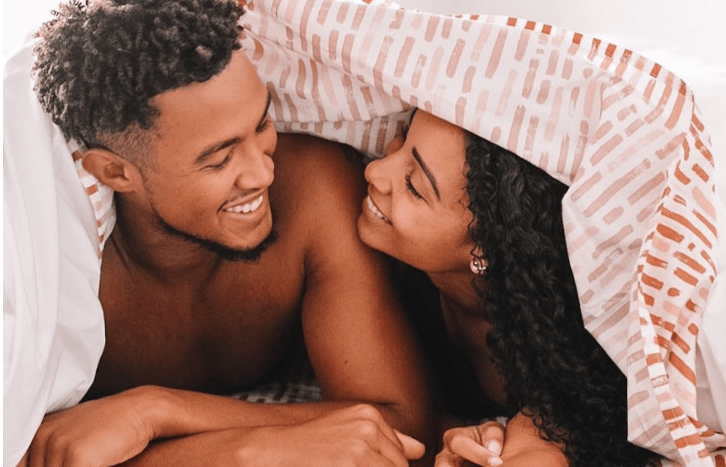 Couple under sheets (Courtesy of @tenesiaandterence)